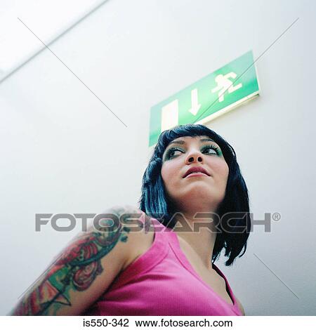 Stock Image - Woman with tattooed arm. Fotosearch