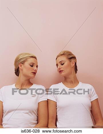 Women looking at each other's badges View Large Photo Image Stock Photo - Women looking at each other's badges. Fotosearch