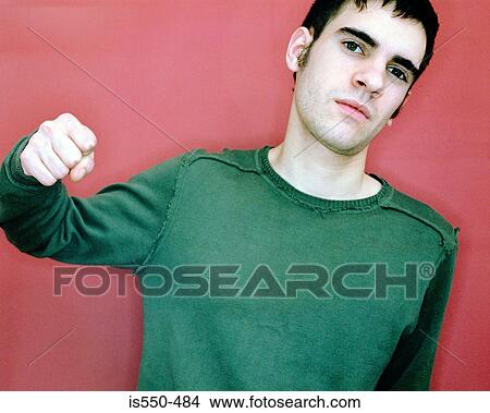 Picture - Young man holding up his fist. Fotosearch