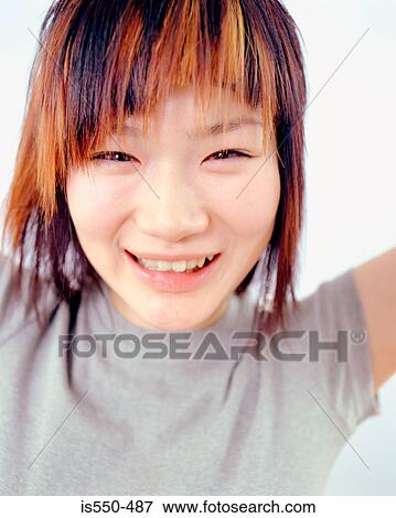 Young Oriental woman smiling View Large Photo Image Stock Photo - Young Oriental woman smiling. Fotosearch