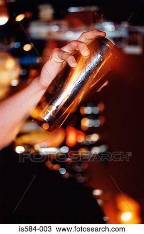 Bartender holding cocktail shaker View Large Photo Image Stock Image - Bartender holding cocktail shaker. Fotosearch