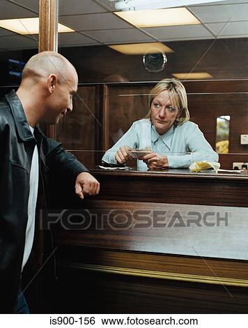 Betting shop worker counting money for customer View Large Photo Image Stock Photograph - Betting shop worker counting money for customer. Fotosearch