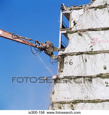 Crane demolishing a building View Large Photo Image Stock Photo - Crane demolishing a building. Fotosearch