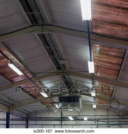 Stock Photo - Fluorescent lighting on factory ceiling. Fotosearch