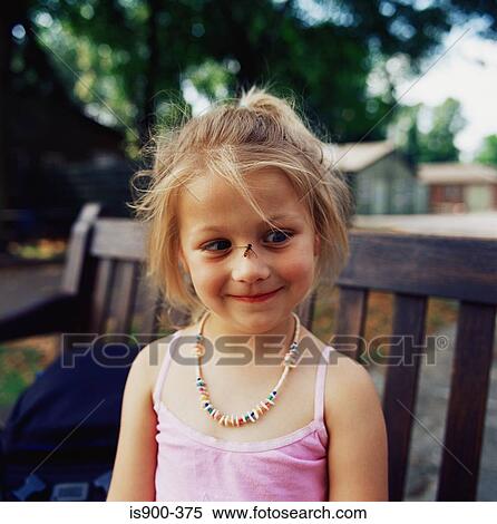Stock Photography - Girl with a hover fly on her nose. Fotosearch