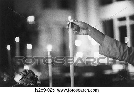 Hand lighting a candle View Large Photo Image Stock Photography - Hand lighting a candle. Fotosearch