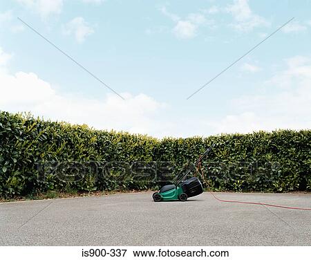 Lawnmower in a concrete garden View Large Photo Image Stock Photo - Lawnmower in a concrete garden. Fotosearch