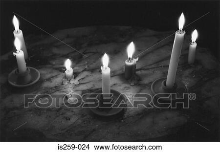 Picture - Lit candles on marble surface. Fotosearch