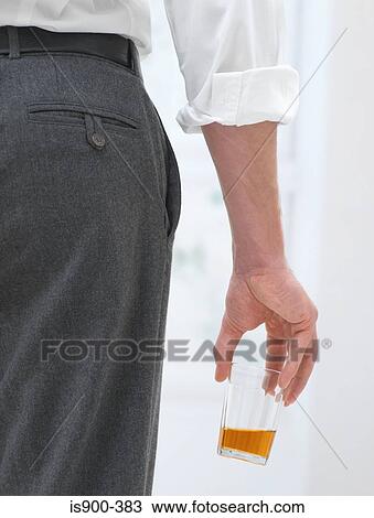 Man holding a glass of beer View Large Photo Image Stock Image - Man holding a glass of beer. Fotosearch