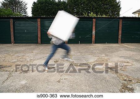 Stock Image - Man holding board and running. Fotosearch