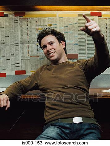 Stock Image - Man in a betting shop. Fotosearch