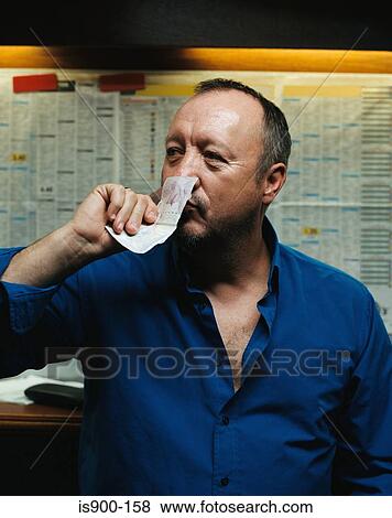 Man smelling a twenty pound note View Large Photo Image Stock Photo - Man smelling a twenty pound note. Fotosearch