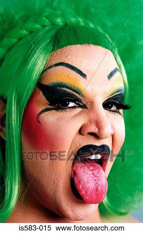 Stock Photography - Portrait of a transvestite wearing a green wig. Fotosearch