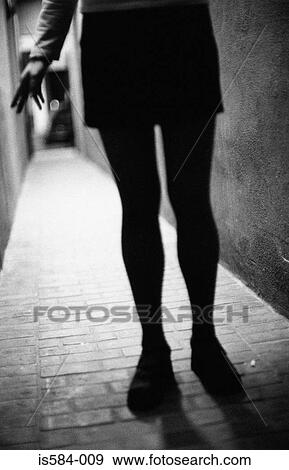 Stock Photo - Silhouetted woman in alley. Fotosearch