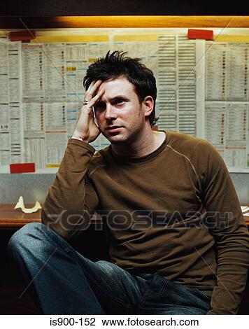 Stock Image - Stressed man in a betting shop. Fotosearch