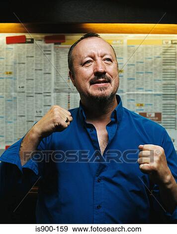 Stock Photo - Successful man in a betting shop. Fotosearch
