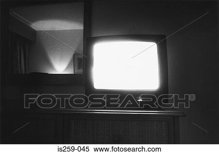 Television on in dimly lit room View Large Photo Image Stock Photography - Television on in dimly lit room. Fotosearch
