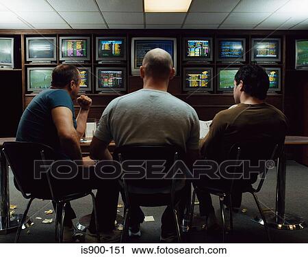 Three men in a betting shop View Large Photo Image Stock Image - Three men in a betting shop. Fotosearch