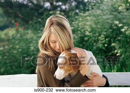Woman holding pet dog View Large Photo Image Stock Image - Woman holding pet dog. Fotosearch