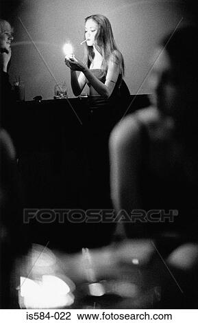 Woman smoking in bar View Large Photo Image Stock Image - Woman smoking in bar. Fotosearch