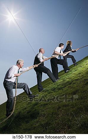 Business people climbing hill with rope View Large Photo Image Stock Photo - Business people climbing hill with rope. Fotosearch