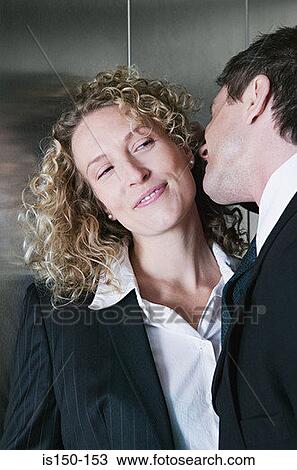 Stock Image - Businessman and businesswoman flirting. Fotosearch
