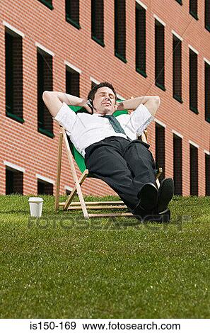 Stock Photo - Businessman sitting in a deckchair. Fotosearch