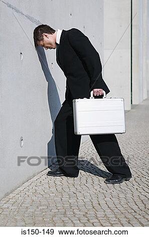 Businessman with his head against a wall View Large Photo Image Stock Photo - Businessman with his head against a wall. Fotosearch