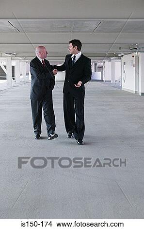 Businessmen in a car park View Large Photo Image Picture - Businessmen in a car park. Fotosearch