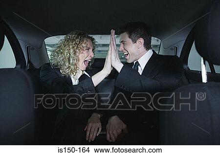 Colleagues in car doing a hi five View Large Photo Image Picture - Colleagues in car doing a hi five. Fotosearch