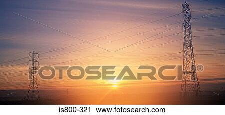 Stock Image - Electricity pylons at sunrise. Fotosearch