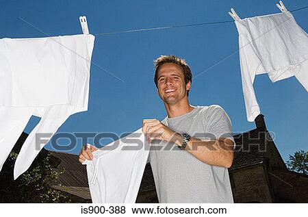 Man hanging out washing View Large Photo Image Stock Photo - Man hanging out washing. Fotosearch
