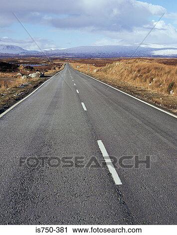 Stock Image - Road through Scottish Highlands. Fotosearch