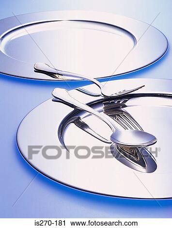 Stock Image - Silver plates and cutlery. Fotosearch
