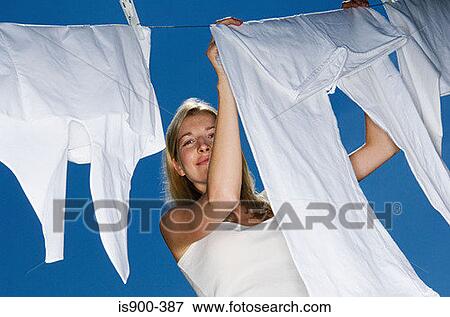 Woman hanging out washing View Large Photo Image Stock Photo - Woman hanging out washing. Fotosearch