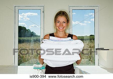 Woman holding pile of towels View Large Photo Image Picture - Woman holding pile of towels. Fotosearch