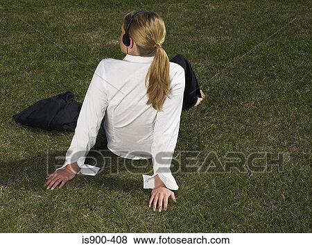 Stock Photo - Young woman listening to music. Fotosearch
