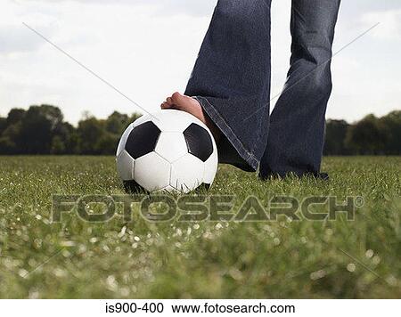 Stock Image - Young woman with a football. Fotosearch