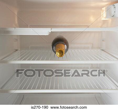 Champagne bottle in a refrigerator View Large Photo Image Stock Image - Champagne bottle in a refrigerator. Fotosearch