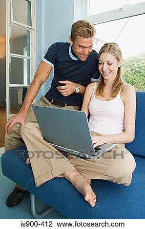 Stock Image - Couple using a laptop computer. Fotosearch