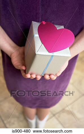 Girl holding gift behind her back View Large Photo Image Stock Image - Girl holding gift behind her back. Fotosearch