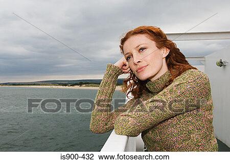 Stock Image - Thoughtful looking woman on a ship. Fotosearch