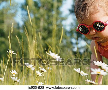 Toddler looking at flowers View Large Photo Image Stock Photo - Toddler looking at flowers. Fotosearch