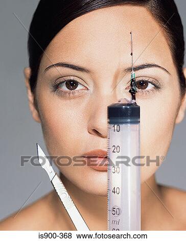 Woman with syringe and scalpel View Large Photo Image Stock Photo - Woman with syringe and scalpel. Fotosearch