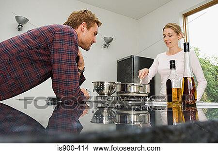 Picture - Young couple in the kitchen. Fotosearch