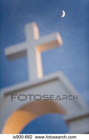 Stock Image - Moon over cross of church. Fotosearch