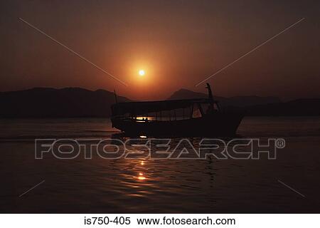 Boat on ocean at sunset View Large Photo Image Stock Photography - Boat on ocean at sunset. Fotosearch