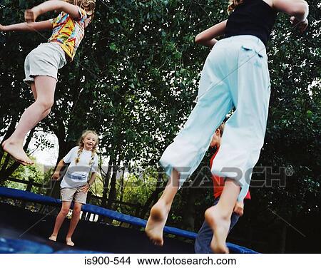 Picture - Children bouncing on trampoline. Fotosearch