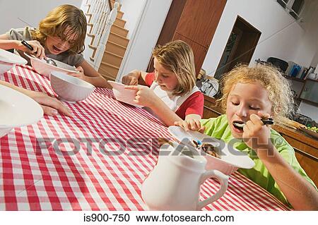 Stock Image - Children eating dessert. Fotosearch