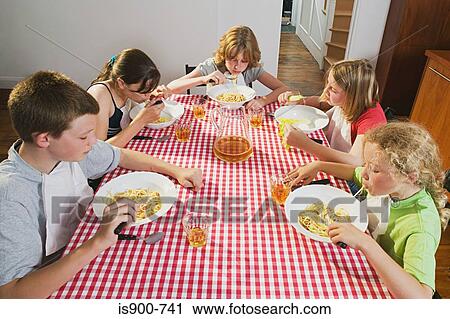 Stock Image - Children eating spaghetti. Fotosearch